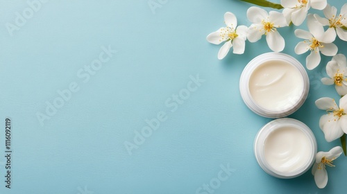Cream jars with green leaves on a light background for skincare and beauty ro...