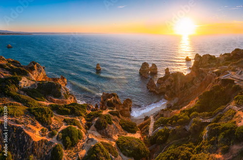 Aerial view of rock formation at Camilo beach in Algarve, Portugal during sunrise 
