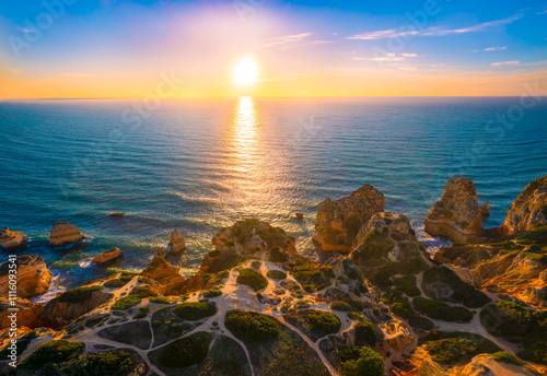 Aerial view of O Elefante rock formation at coast of Algarve, Portugal during sunrise