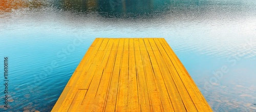 Vibrant yellow dock extending over tranquil blue water reflecting a serene landscape ideal for boating and relaxation. photo