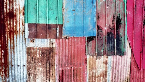 multi-colored roof covered with different old rusty materials of various colors	