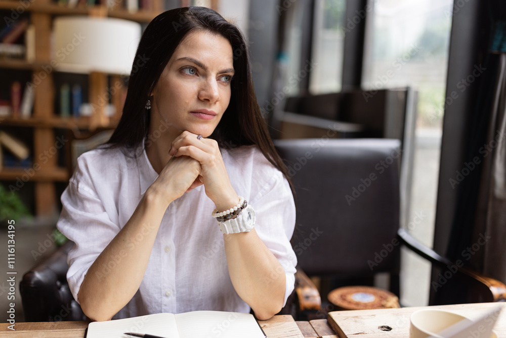 Young Caucasian business woman with long brunette hair working on laptop in cafe. College student using technology , online education, freelance Young Caucasian business woman with long brunette hair working on laptop in cafe. College student using technology , online education, freelance