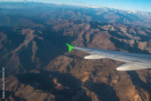 Aerial view of the Andes mountain range from the window of an airline plane at sunset.