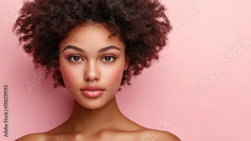 Portrait of a beautiful young black woman with an afro hairstyle against a pink background, capturing her elegance and personality in a close-up style with ample copy space.