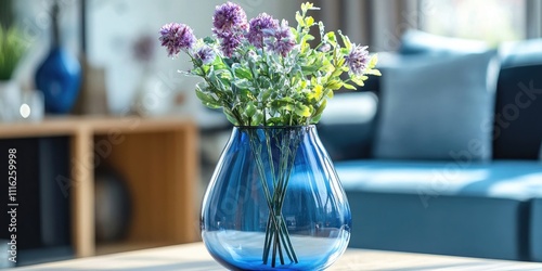 Vintage blue glass vase with a transparent design, showcasing exquisite craftsmanship, ideal for enhancing any space with its unique vintage charm. This vintage glass vase beautifully reflects light. photo