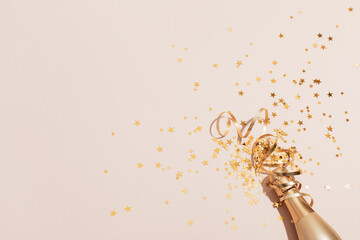 Party background with champagne and golden confetti stars. Christmas, birthday or wedding concept. Flat lay.