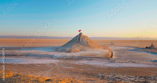 Red flag on the top point of deserted tunisian lake Chott el Djerid. Very arid conditions in Africa almost dried lake. photo