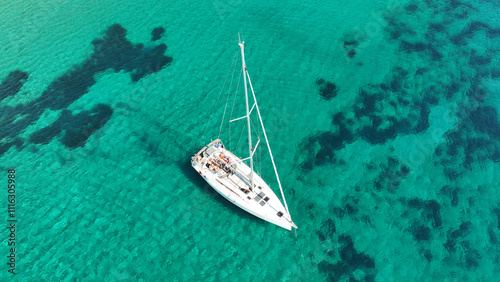 Obraz na płótnie Aerial drone photo of luxury sail boat anchored in paradise bay of Ornos in island of Mykonos, Cyclades, Greece w salonie