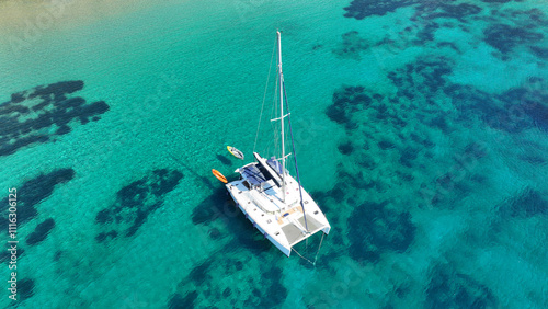 Aerial drone photo of luxury sail boat anchored in paradise bay of Ornos in island of Mykonos, Cyclades, Greece