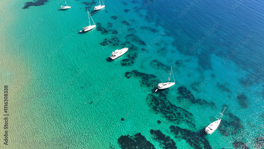 Aerial drone photo of luxury sail boat anchored in paradise bay of Ornos in island of Mykonos, Cyclades, Greece