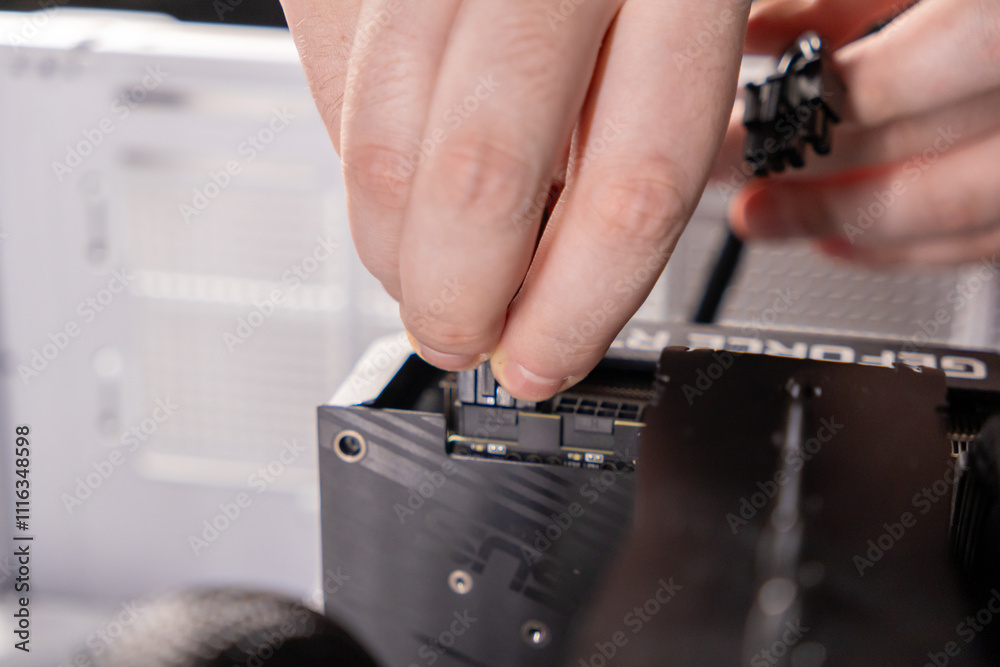 connecting gpu power cables for pc assembly, hands installing graphics ...