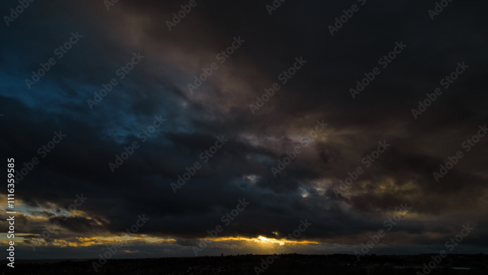 Fototapeta premium Sunset Behind Dark Cloud Cover