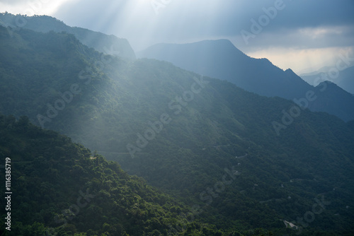 Sun lights up the mountains somewhere in the western ghats photo