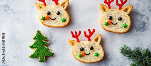 Creative kids breakfast featuring funny reindeer and tree-shaped sandwiches on a neutral background with copy space for festive themes photo