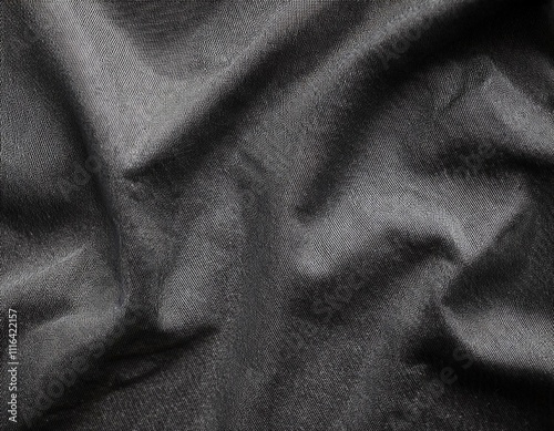 Dark colored fabric folds as background texture