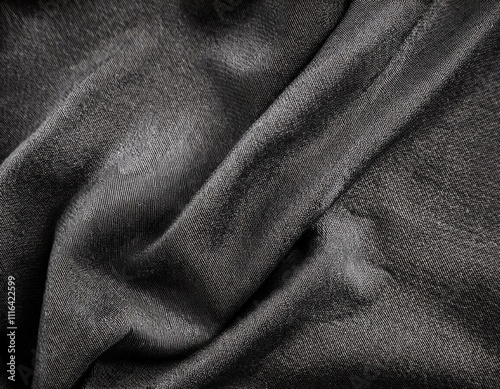 Dark colored fabric folds as background texture