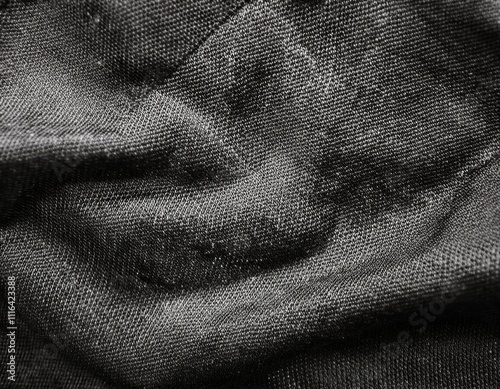 Dark colored fabric folds as background texture