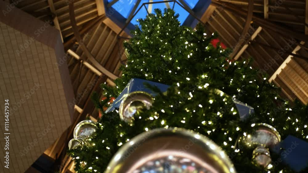 A view from the bottom up of a decorated Christmas tree in a shopping ...