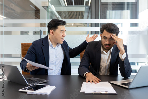 Angry colleague yelling at a stressed employee in a modern office setting. This scene captures workplace conflict, frustration, and pressure as they engage in a heated discussion over paperwork.