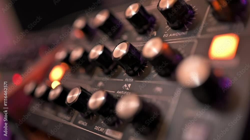 Artistic focus shift on an analog synthesizer with illuminated knobs in a vibrant music studio setting Artistic focus shift on an analog synthesizer with illuminated knobs in a vibrant music studio setting