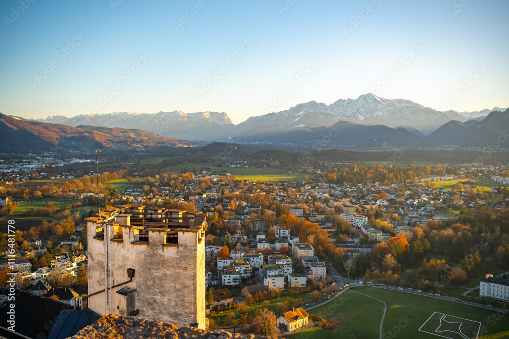 Obraz premium Salzburg, Austria. Magnificent view from Hohensalzburg Castle of the Salzburg area surrounded by Alpine mountains. The city is illuminated by the rays of the setting sun