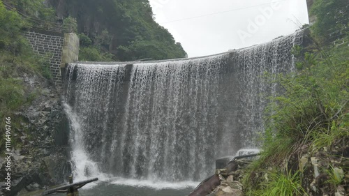 A lush green jungle scene with a small waterfall in a small river in Nanxijiang Wenzhou zhejiang china. High quality 4k footage photo