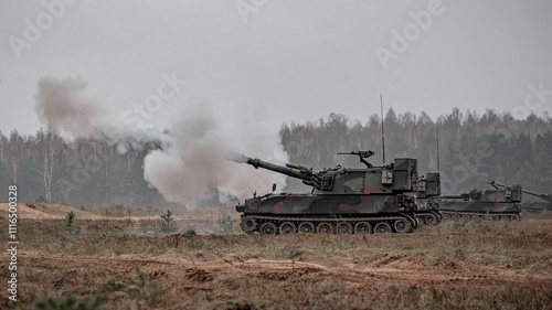 Self propelled howitzer shooting in field