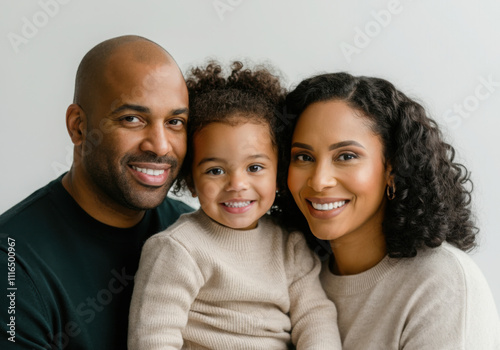 Smiling parents with their young daughter, portraying a happy and loving family unit photo