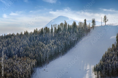 silhouette of a mountain peak on the horizon, a landscape at a ski resort and...