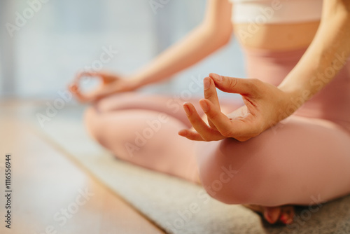 Wallpaper Mural Close up. A woman meditates or practices yoga, sitting on a mat in a spacious, bright studio. Torontodigital.ca