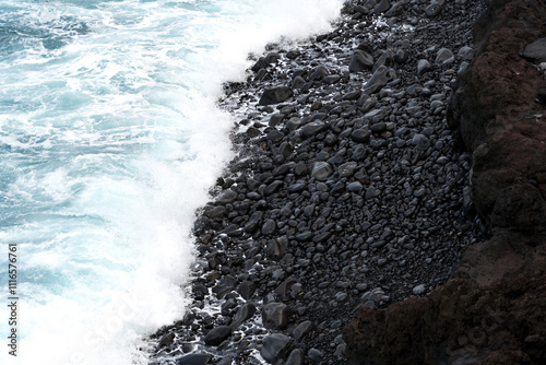 North coast of Tenerife, Canary Islands, waves breaking against dark lava rocks, view from top. photo