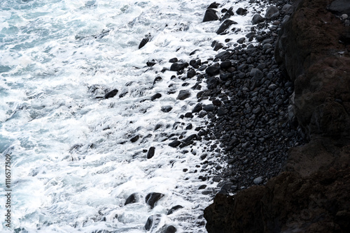 North coast of Tenerife, Canary Islands, waves breaking against dark lava rocks, view from top.