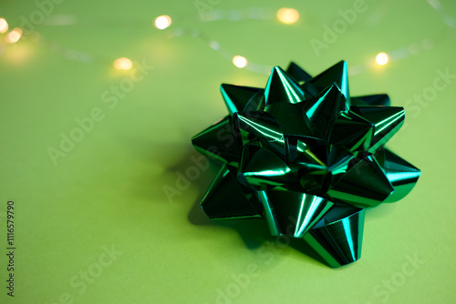 An Elegant Green Gift Bow beautifully placed on a Soft and Light Background that enhances its charm