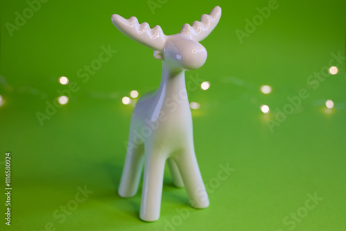 Stylized White Moose Figurine displayed on a vibrant Green Background for artistic appeal