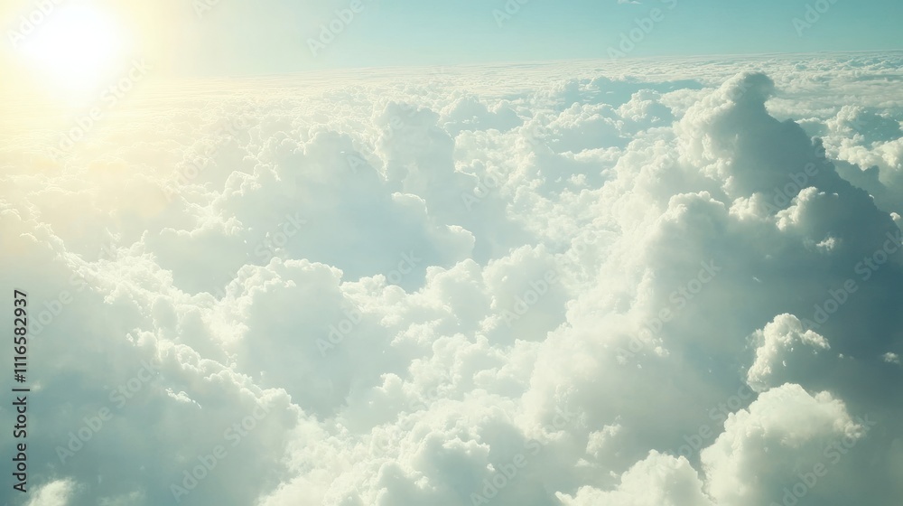 Fototapeta premium Aerial view of fluffy white clouds illuminated by sunlight.