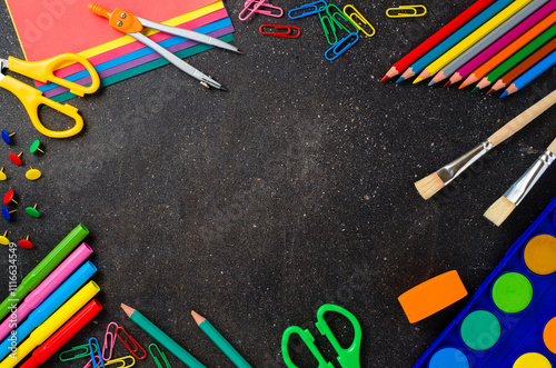 School supplies on dark table.