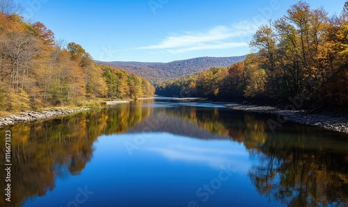 Serene river reflecting autumn foliage, clear blue sky, mountains in background, tranquil scene