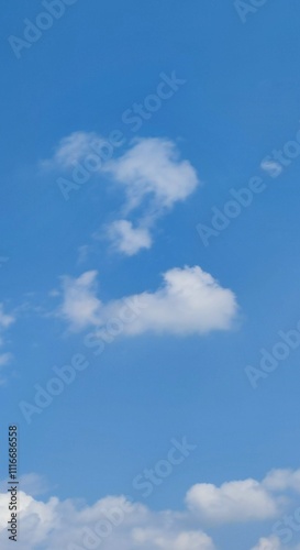 A lonely cloud in the sky. A summer sunny day, a small white fluffy cloud hangs in the blue sky. The cloud resembles the letter Z of the English alphabet. The image was made from several white strokes