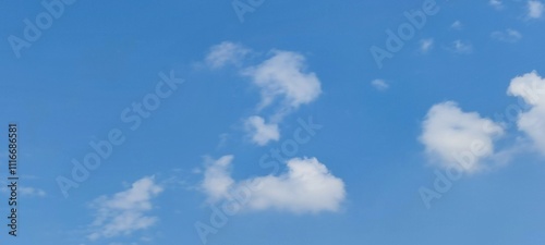 A lonely cloud in the sky. A summer sunny day, a small white fluffy cloud hangs in the blue sky. The cloud resembles the letter Z of the English alphabet. The image was made from several white strokes