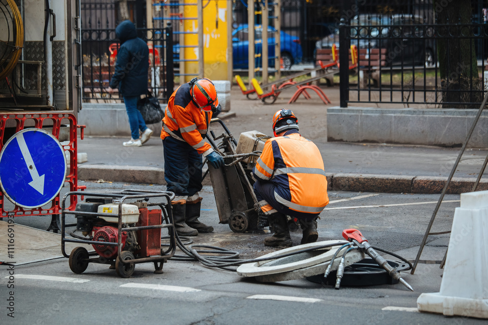 Obraz premium Roadworkers on repair of road surface