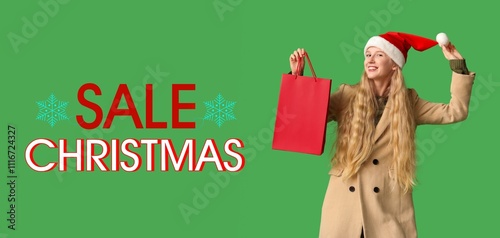 Young woman in Santa hat an...