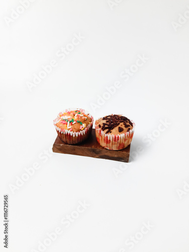 Banana muffin or banana cupcake with sprinkles an isolated white background