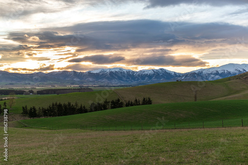 Picturesque Rural Farmland and Mountainous Backdrop photo