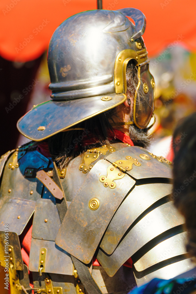 detail of an ancient roman soldiers, roman legionnaires with helmet and metallic armour armor at a historical festival detail of an ancient roman soldiers, roman legionnaires with helmet and metallic armour armor at a historical festival