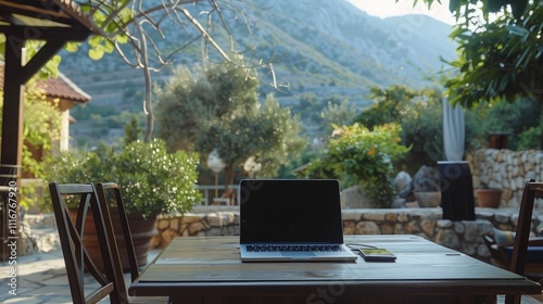 laptop computer With mobile phone on table in coffee shop with hills background