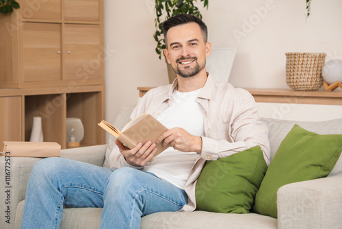 Smiling man relaxing on sof...