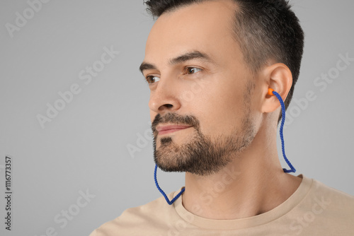 Handsome man with earplugs ...