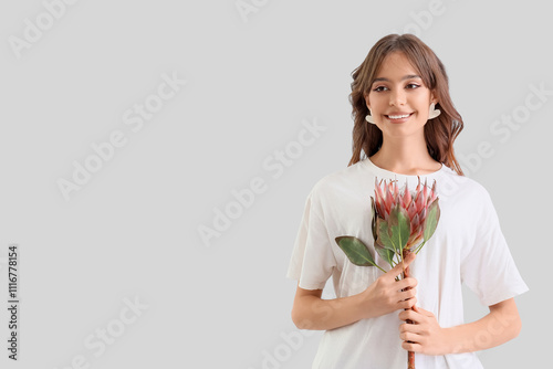 Young woman with protea flo...