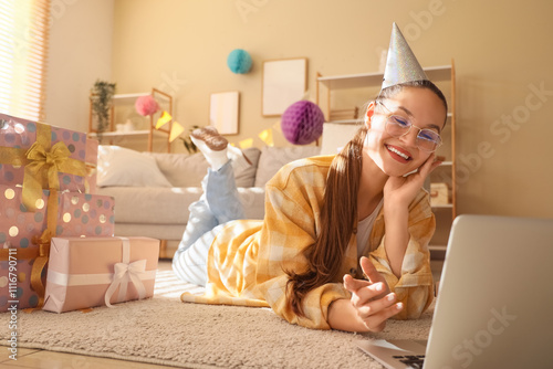 Young woman in party hat wi...