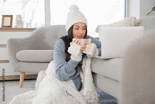 Frozen young woman with cup...
